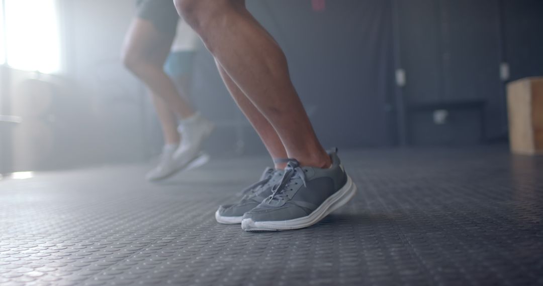 Men Exercising in Gym with Emphasis on Athletic Shoes