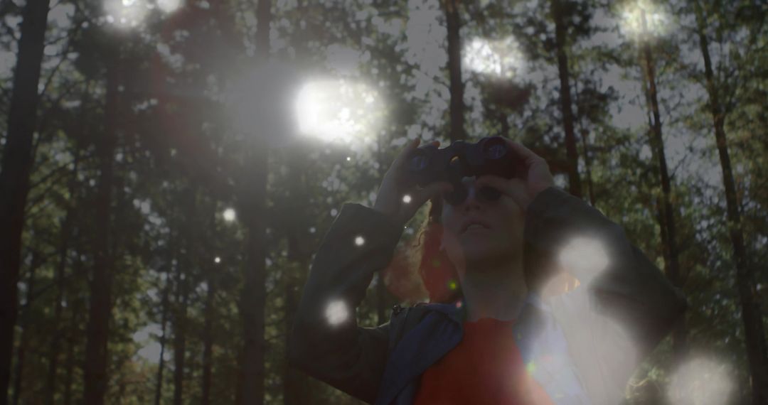 Woman Hiker with Binoculars Exploring Dense Forest