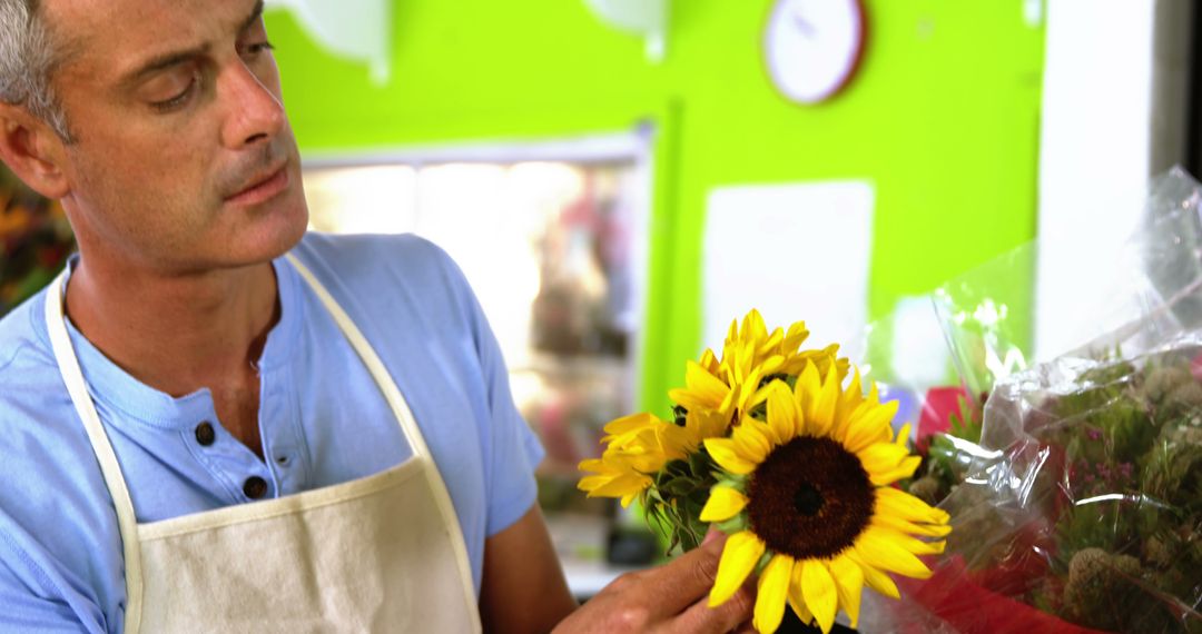 Male Florist Arranging Fresh Sunflowers in Flower Shop - Free Images, Stock Photos and Pictures on Pikwizard.com