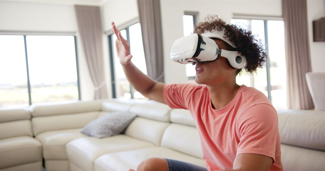 Young Man Engaging with VR Headset at Home