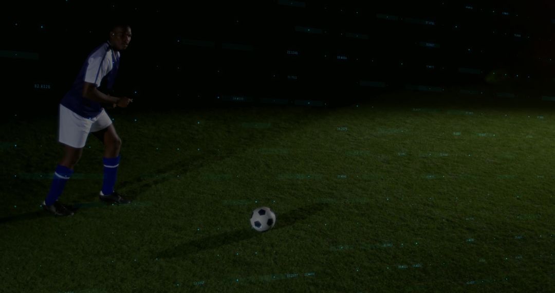 Night soccer player preparing to strike ball under spotlight on turf with copy space