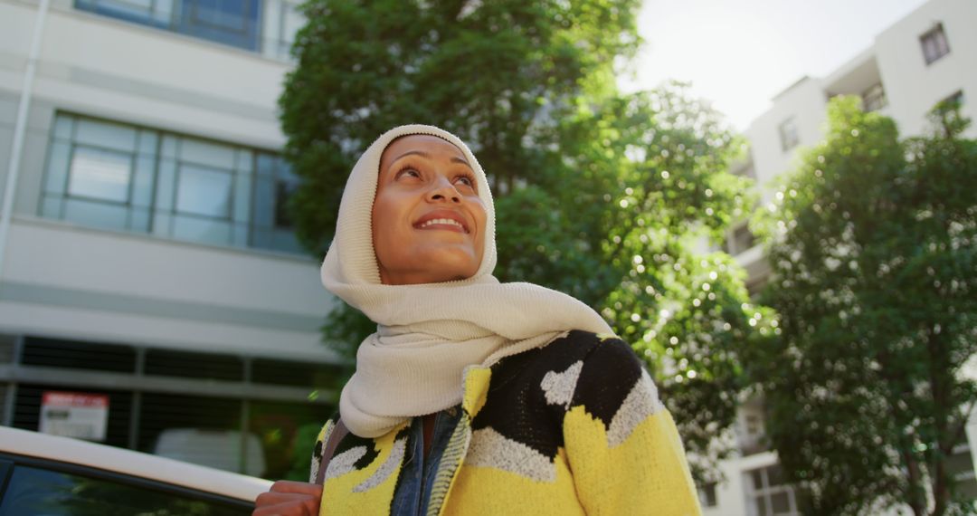 Woman in hijab enjoying sunny day in urban area - Free Images, Stock Photos and Pictures on Pikwizard.com