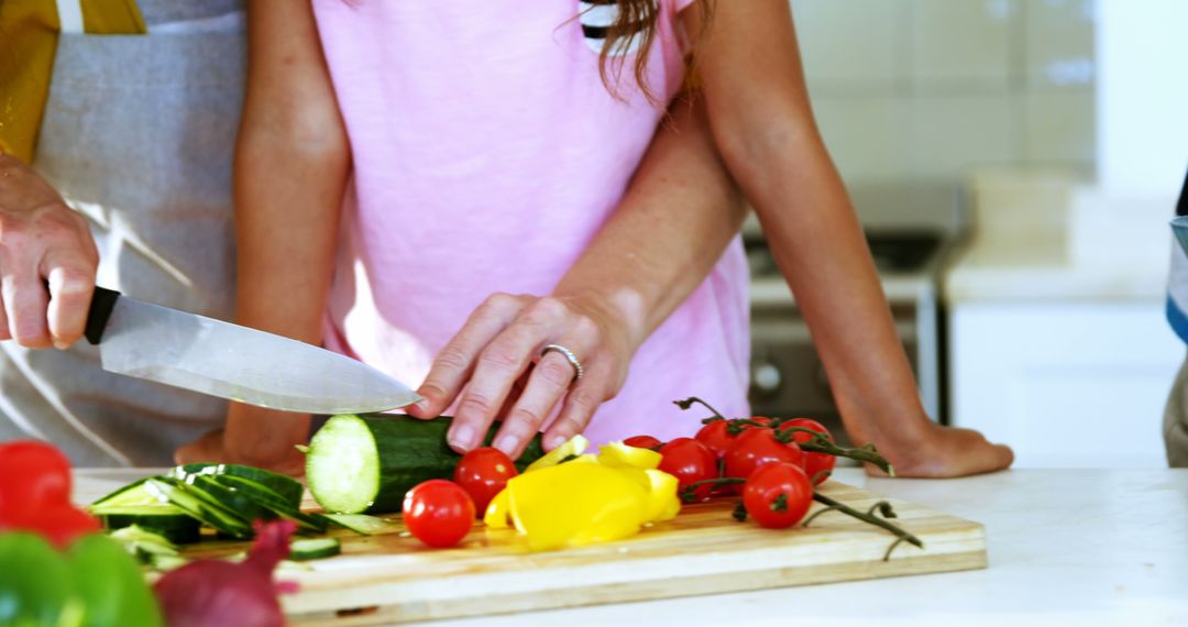 Parent and Child Preparing Fresh Vegetable Salad in Kitchen - Free Images, Stock Photos and Pictures on Pikwizard.com