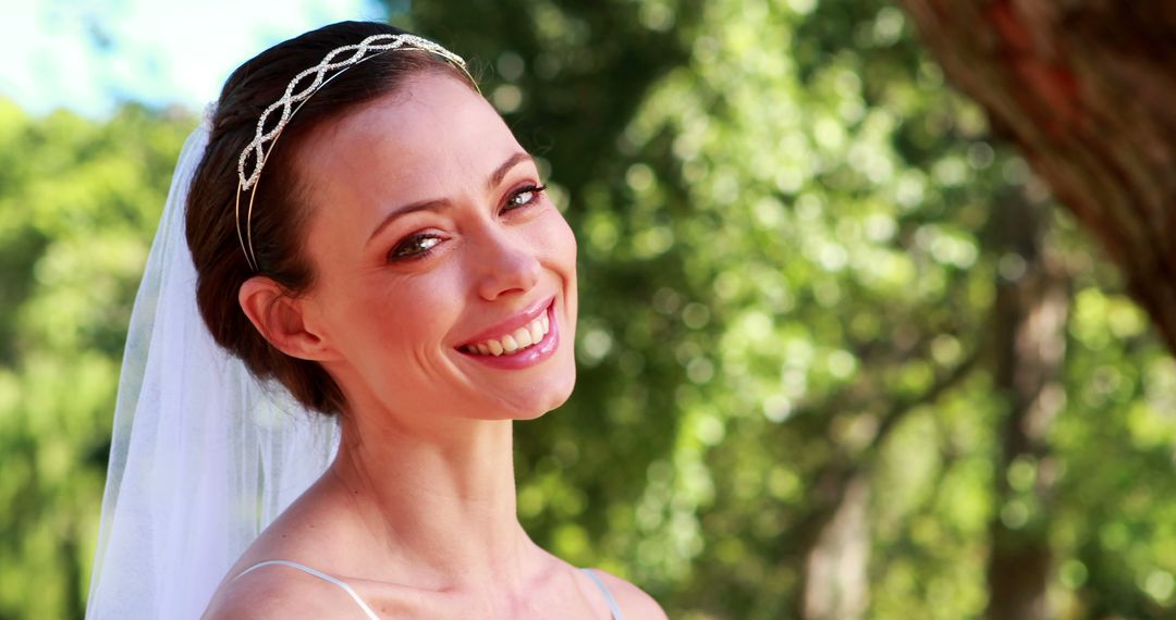 Smiling Bride Outdoors with Bridal Veil on Wedding Day - Free Images, Stock Photos and Pictures on Pikwizard.com