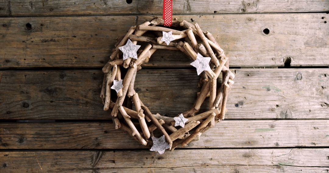 A rustic wooden wreath adorned with stars hangs on a textured wooden background, with copy space - Free Images, Stock Photos and Pictures on Pikwizard.com