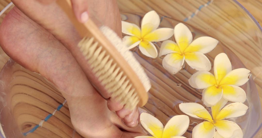 Relaxing Foot Spa with Frangipani and Soft Brush Scrub - Free Images, Stock Photos and Pictures on Pikwizard.com