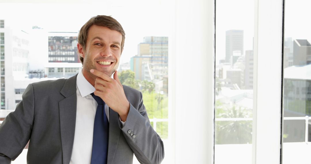 Happy businessman smiling in modern office - Free Images, Stock Photos and Pictures on Pikwizard.com