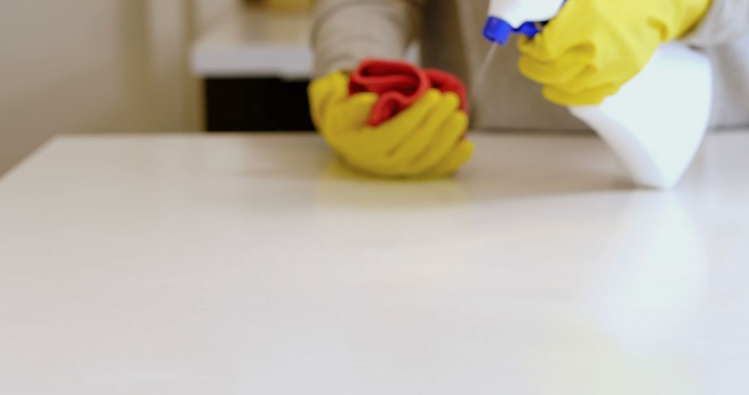 Cleaning Countertop with Yellow Gloves and Red Cloth - Free Images, Stock Photos and Pictures on Pikwizard.com