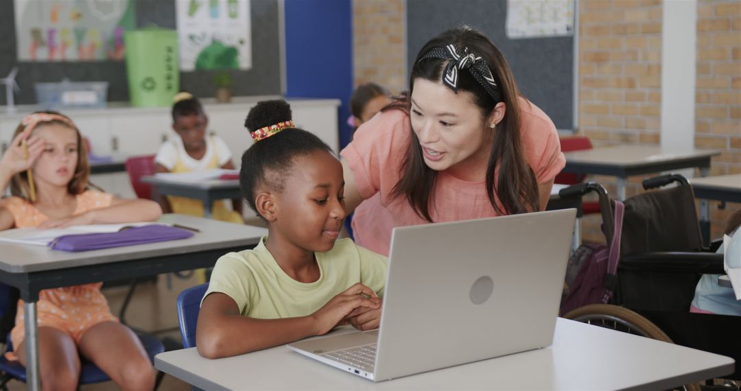 Teacher Helping Student on Laptop in Classroom - Free Images, Stock Photos and Pictures on Pikwizard.com