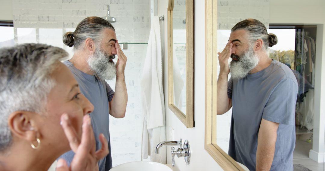 Senior Couple Engaging in Morning Skincare Routine Mirror Reflection