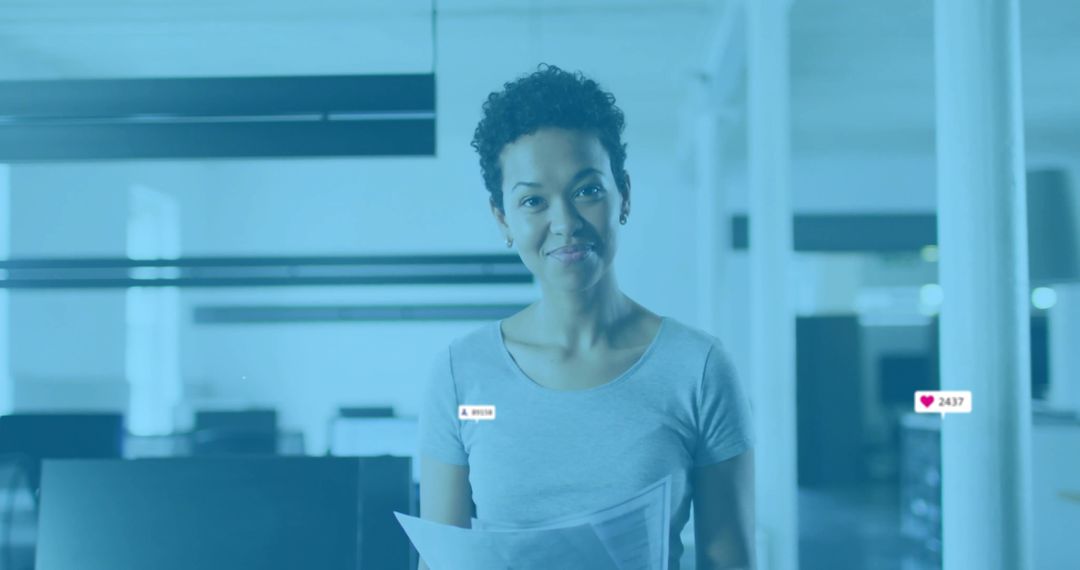 Professional Worker in Open-Plan Office Holding Documents