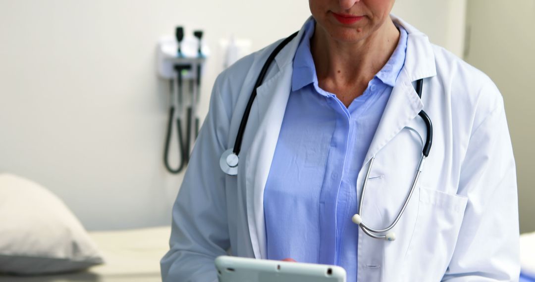 Female Doctor Using Digital Tablet in Hospital Exam Room - Free Images, Stock Photos and Pictures on Pikwizard.com