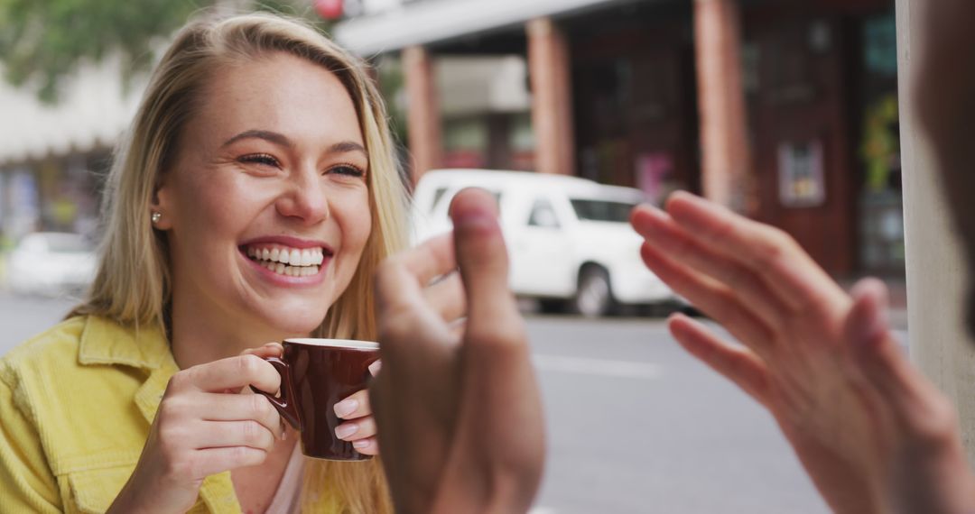 Young Woman Smiling While Drinking Coffee at Outdoor Cafe - Free Images, Stock Photos and Pictures on Pikwizard.com