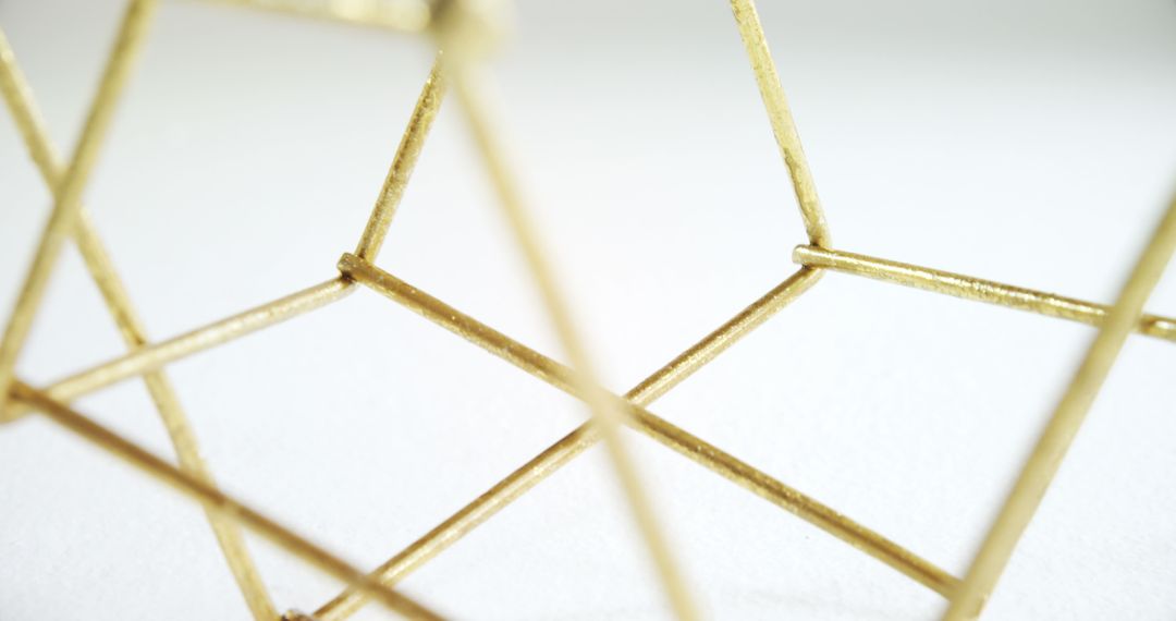 Close-up of Golden Geometric Wireframe Sculpture on White Background - Free Images, Stock Photos and Pictures on Pikwizard.com