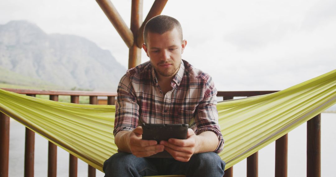 Man Relaxing in Outdoor Hammock Using Smartphone - Free Images, Stock Photos and Pictures on Pikwizard.com