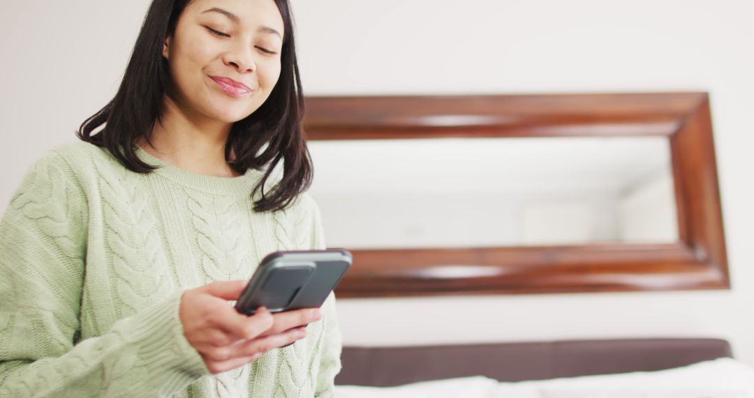 Woman Using Smartphone at Home, Smiling - Free Images, Stock Photos and Pictures on Pikwizard.com