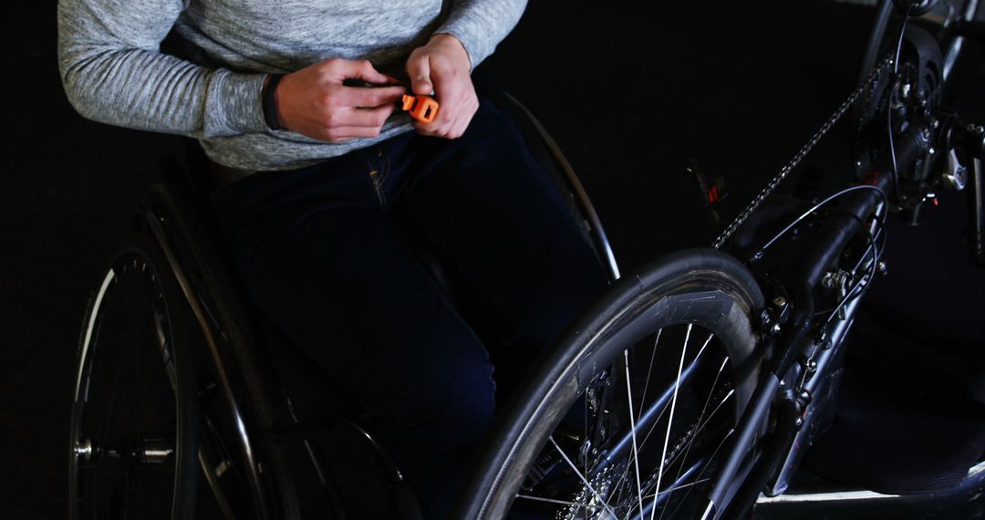 Person Using Wheelchair Hand Bike and Tool for Maintenance - Free Images, Stock Photos and Pictures on Pikwizard.com