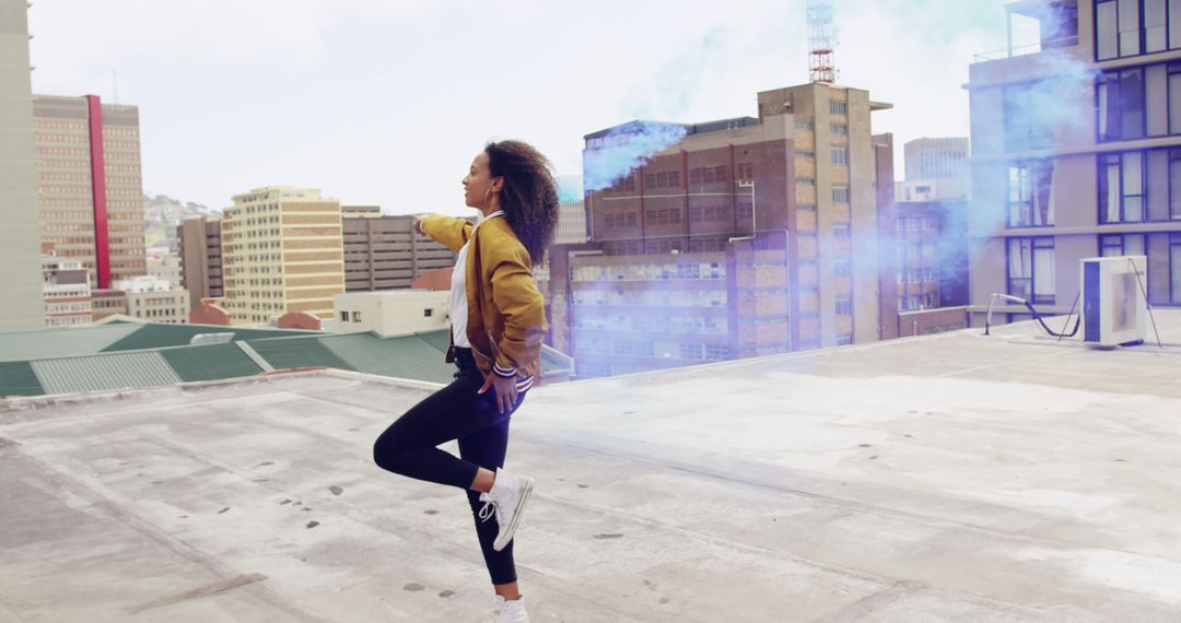 Young Woman Dancing on Rooftop with Smoke Flare in Urban Environment - Free Images, Stock Photos and Pictures on Pikwizard.com