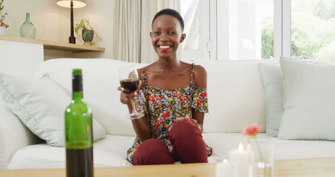 Smiling Woman Drinking Wine on Sofa at Home - Free Images, Stock Photos and Pictures on Pikwizard.com