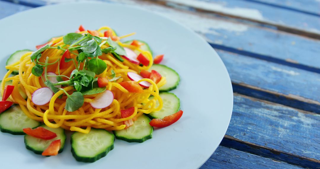 Refreshing Summer Vegetable Noodle Salad on Rustic Blue Table - Free Images, Stock Photos and Pictures on Pikwizard.com