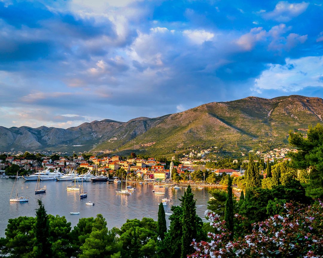 Coastal Scenic View of Mediterranean Village at Sunset with Sailboats and Mountains in Background - Free Images, Stock Photos and Pictures on Pikwizard.com