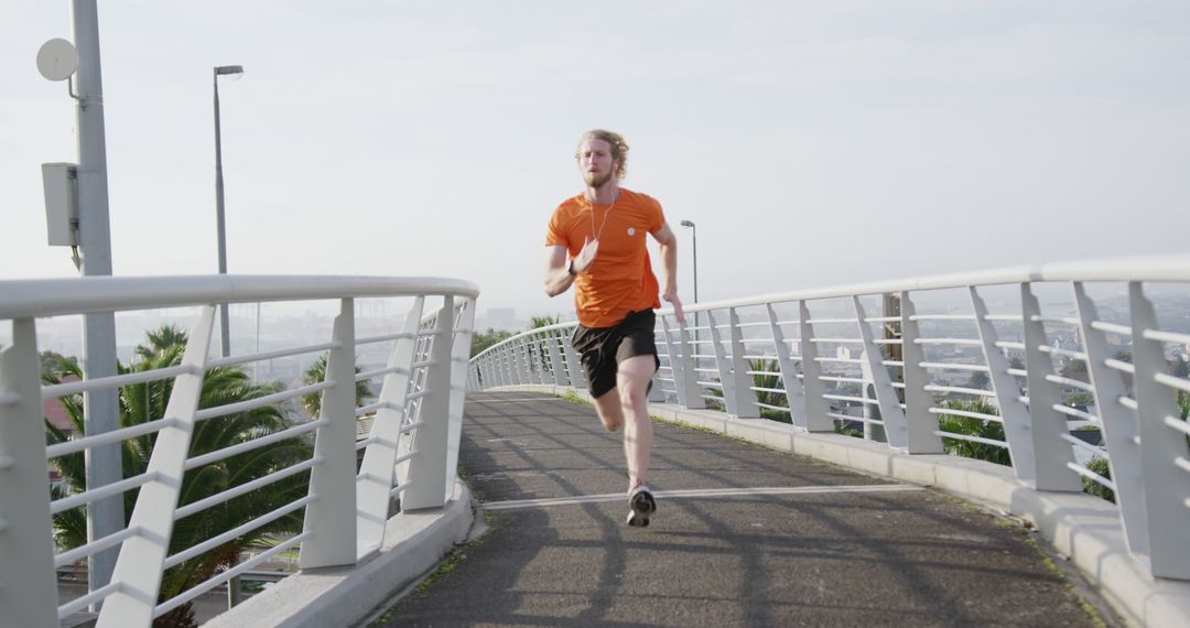 Young Man Running on Urban Bridge for Morning Exercise - Free Images, Stock Photos and Pictures on Pikwizard.com