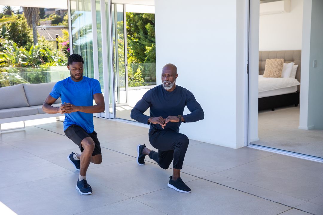 Men Practicing Forward Lunges in Modern Home Setting