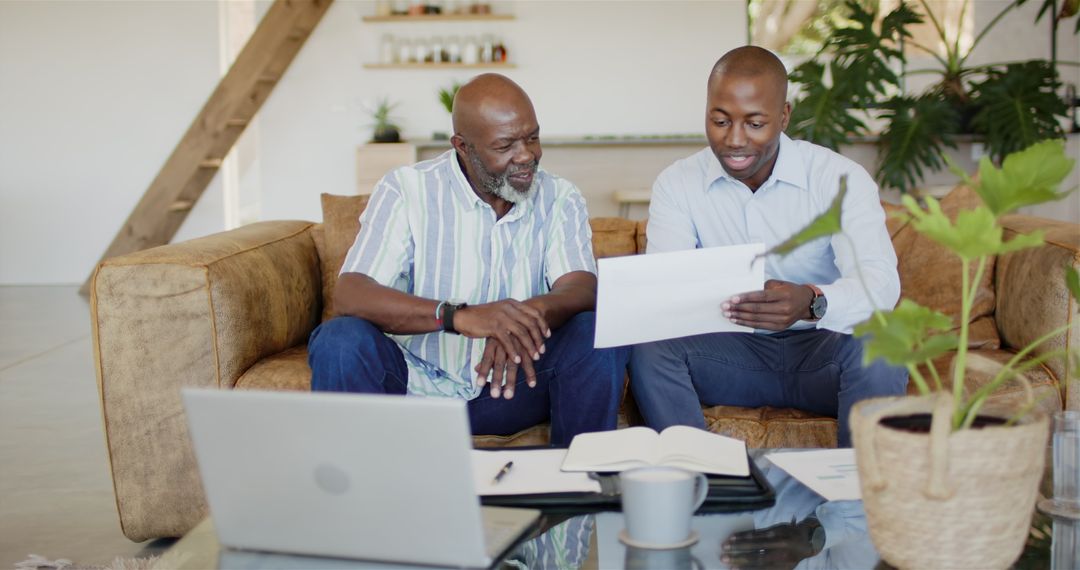 Financial Advisor Reviewing Documents with Client on Couch