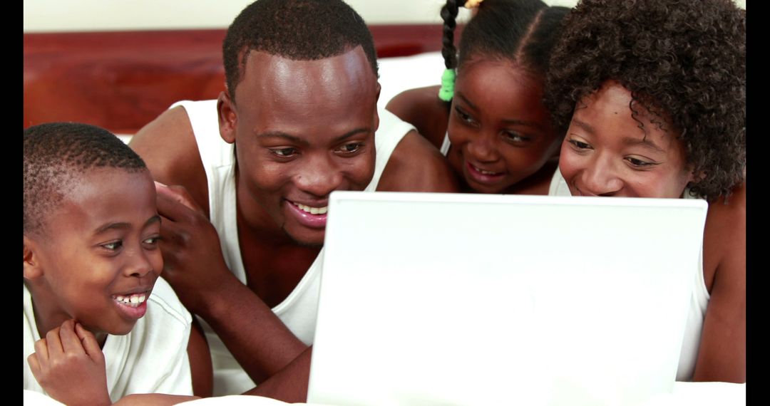 Happy African American Family Watching Movie on Laptop - Free Images, Stock Photos and Pictures on Pikwizard.com