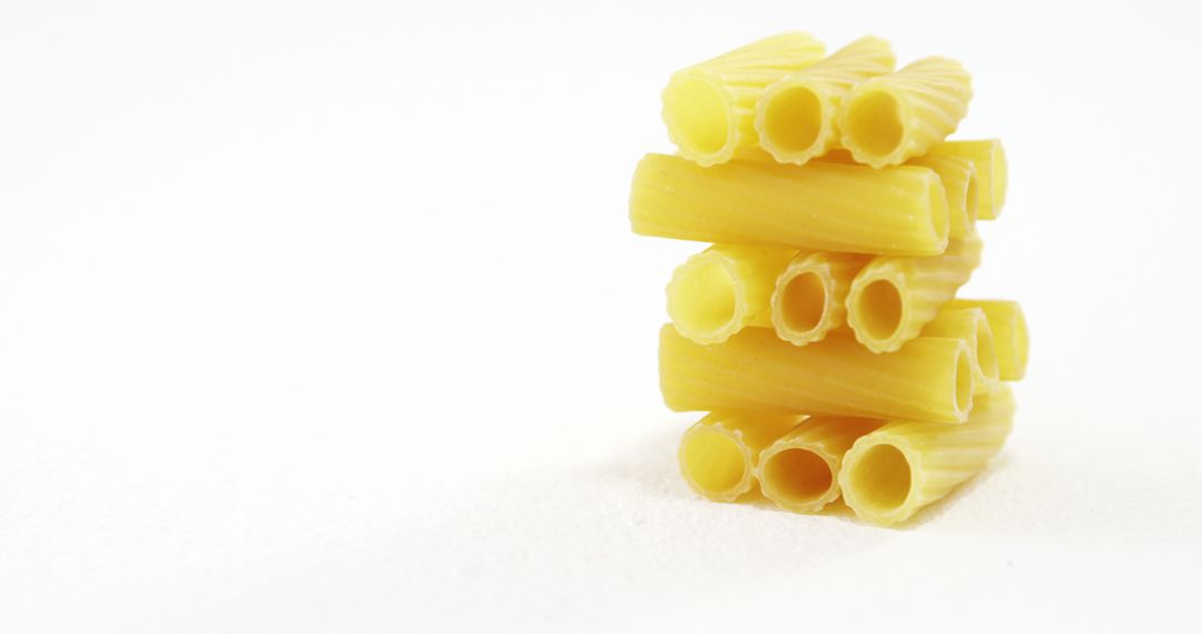 Stacked Rigatoni Pasta on White Background - Free Images, Stock Photos and Pictures on Pikwizard.com