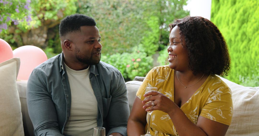 Joyful Couple Enjoying Drinks on Patio