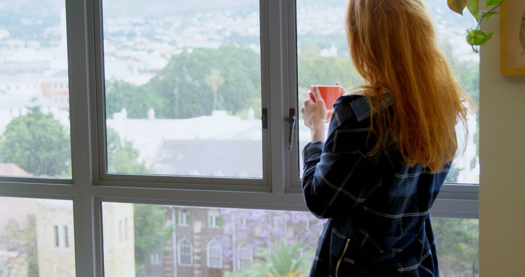 Woman with Red Hair Enjoying Morning Coffee by Window - Free Images, Stock Photos and Pictures on Pikwizard.com