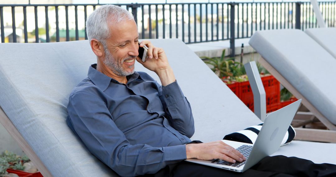 Businessman Relaxing with Laptop on Lounge Chair Outdoors - Free Images, Stock Photos and Pictures on Pikwizard.com