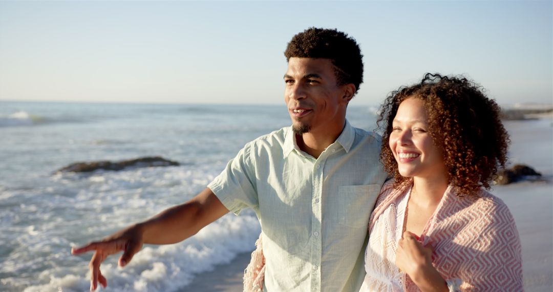 Biracial Couple Enjoying Sunny Day at Beach