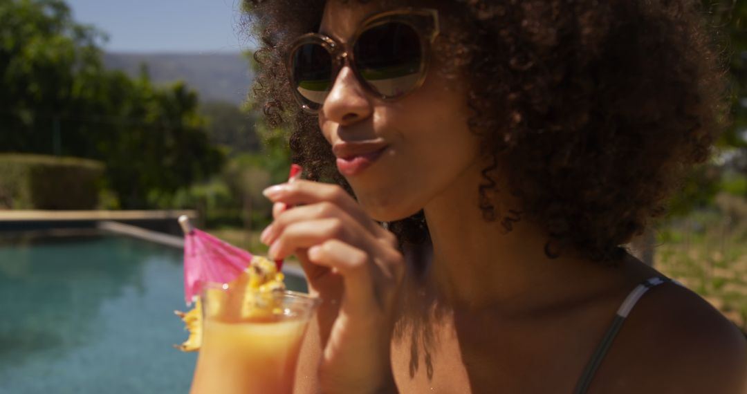 Woman Relaxing by Swimming Pool Drinking Tropical Cocktail - Free Images, Stock Photos and Pictures on Pikwizard.com