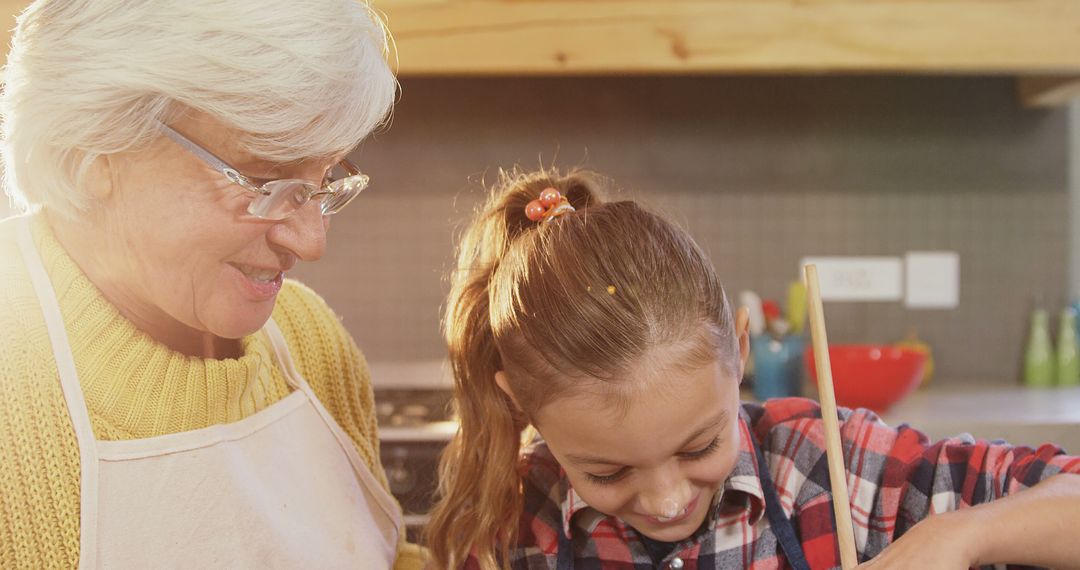 Grandmother and Granddaughter Enjoying Cooking Together - Free Images, Stock Photos and Pictures on Pikwizard.com