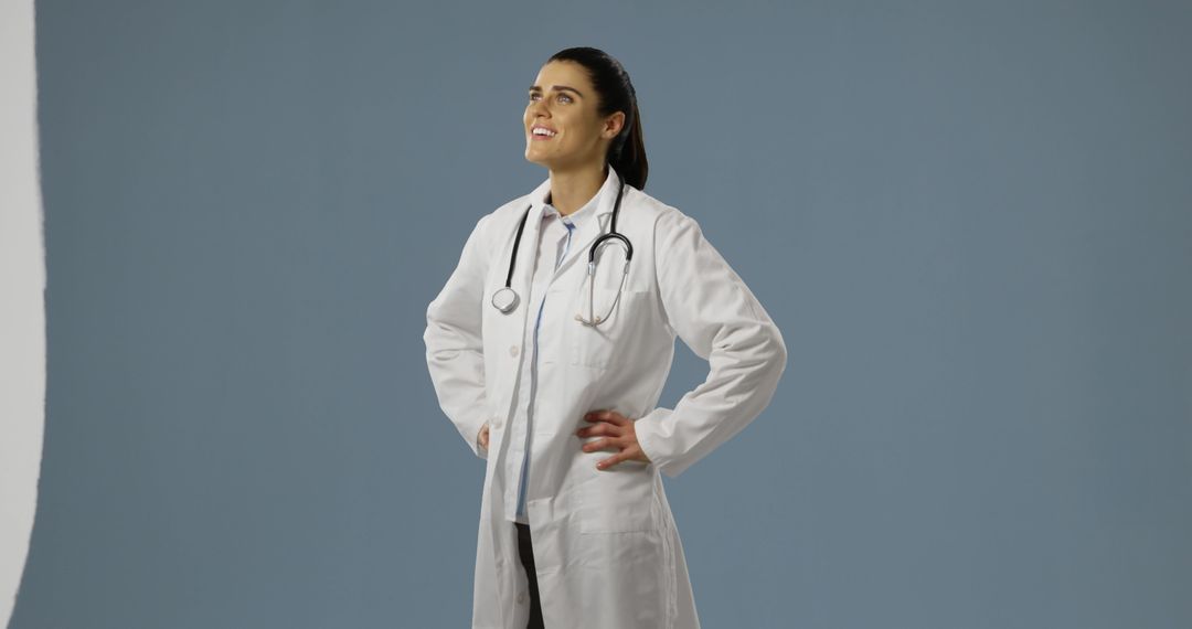 Confident female doctor stands proudly in her white coat, with copy space - Free Images, Stock Photos and Pictures on Pikwizard.com
