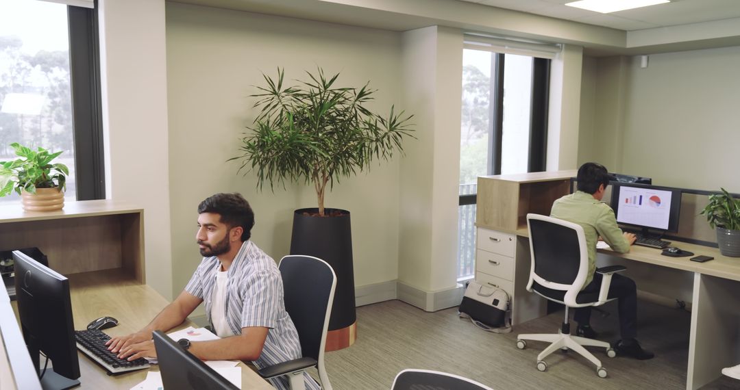 Modern Office with Colleagues and Greenery Enhancing Productivity
