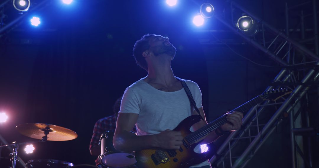 Guitarist Jamming Live on Stage in Dynamic Lighting