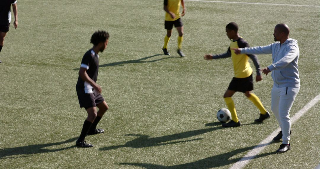 Intense Soccer Match with Players Dribbling Under the Sun