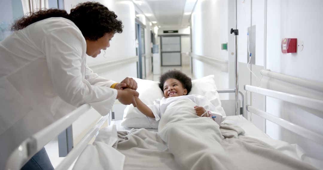 Doctor interacting with child patient in hospital bed - Free Images, Stock Photos and Pictures on Pikwizard.com