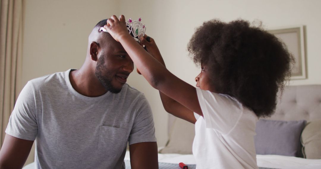 Father and daughter playing with toy crown - Free Images, Stock Photos and Pictures on Pikwizard.com