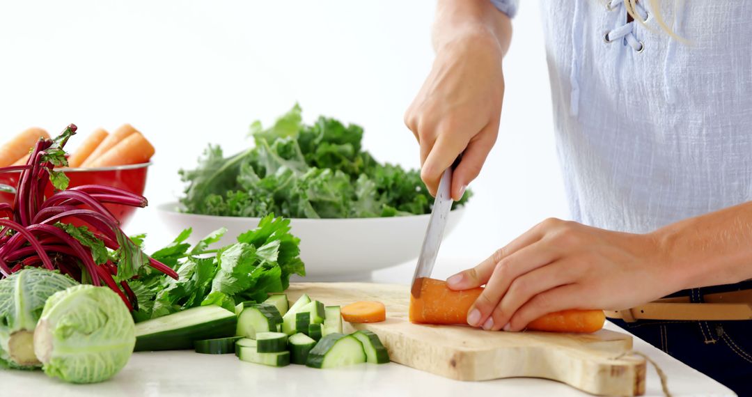 Person Slicing Fresh Vegetables in Modern Kitchen with Bright Background - Free Images, Stock Photos and Pictures on Pikwizard.com