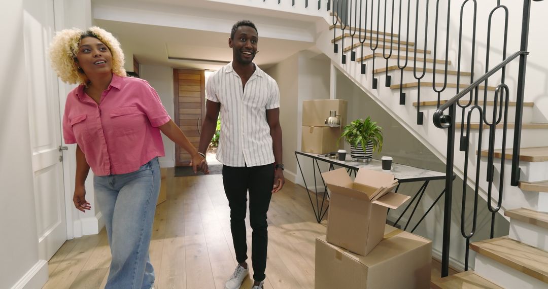 Excited Couple Moving into New Home Packed with Boxes