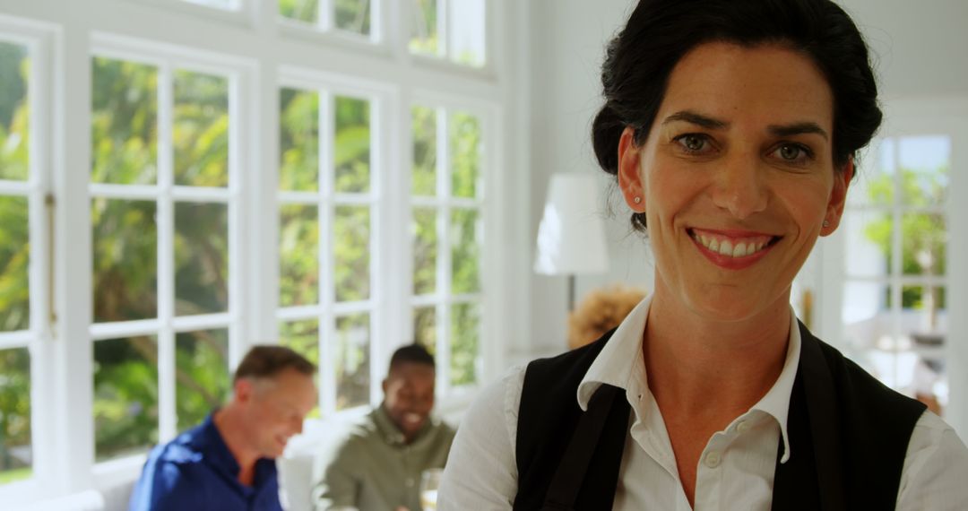Confident Businesswoman Smiling in Front of Colleagues in Office