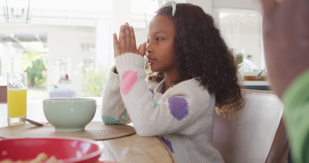 Young Female Child Saying Grace Before Meal at Dining Table - Free Images, Stock Photos and Pictures on Pikwizard.com