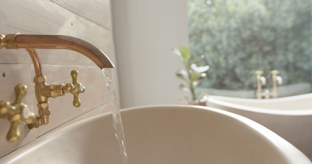 Close-Up of Brass Washbasin with Flowing Water in Rustic Bathroom