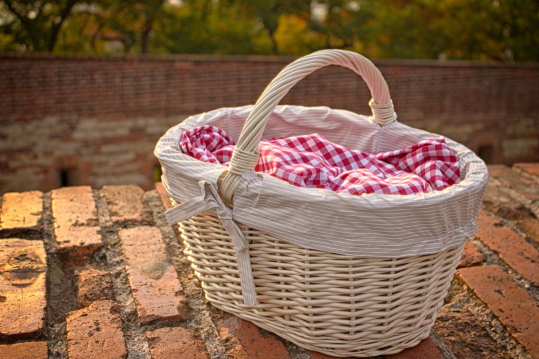 Wicker Picnic Basket on Rustic Brick Wall