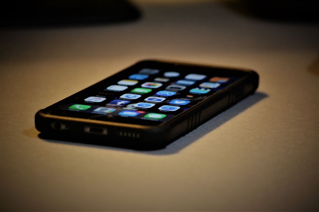 Smartphone on desk with application icons on screen - Free Images, Stock Photos and Pictures on Pikwizard.com