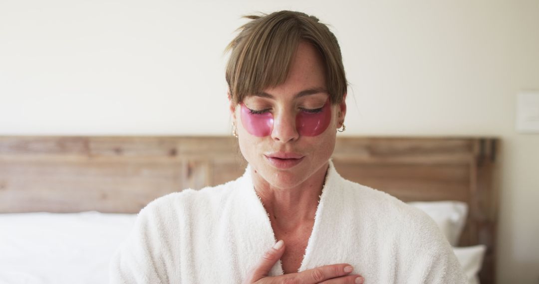 Woman Relaxing at Home with Gel Eye Patches and Spa Robe for Self-Care Day